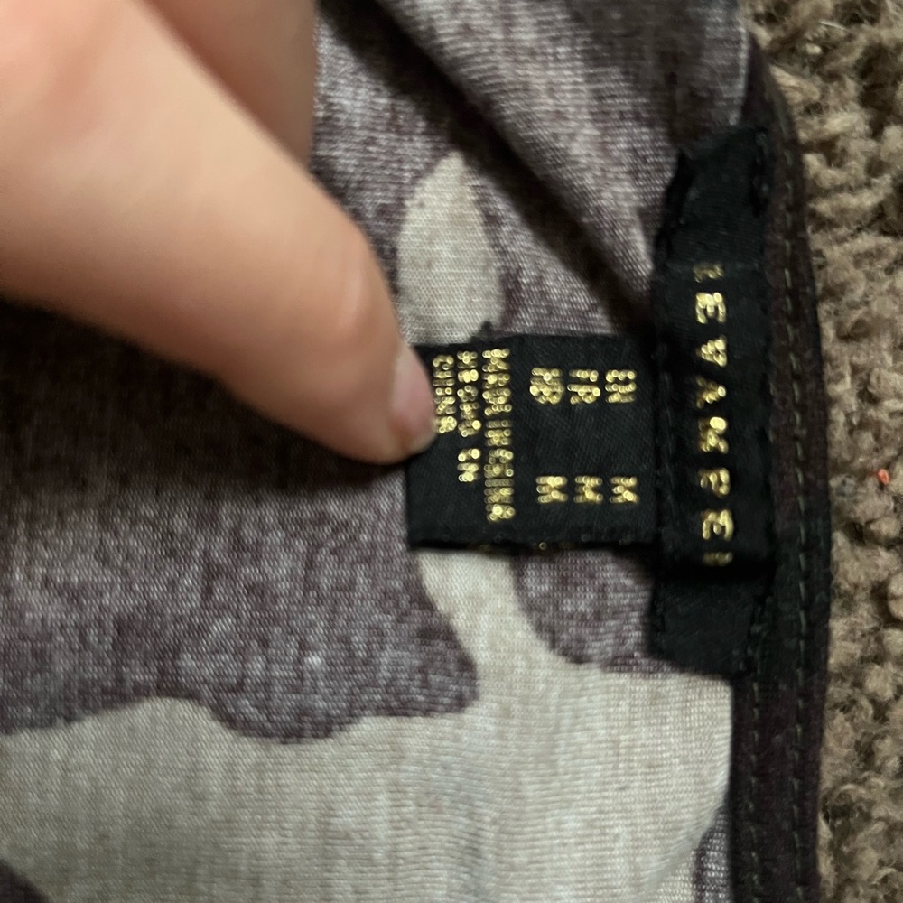 Size medium, barley worn, has adjustable strings on front of shirt